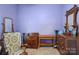 Bedroom with wood furniture, rocking chair and purple walls at 12 Church St, York, SC 29745