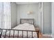 Bedroom features white walls, wood floors and iron bed frame at 12 Church St, York, SC 29745