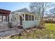 Exterior view showcasing the home's backyard, pergola and screened porch, capturing the outdoor living spaces at 12 Church St, York, SC 29745