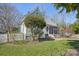 View of the front exterior showcasing the lawn, home and picket fence at 12 Church St, York, SC 29745