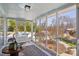Enclosed sunroom with a patterned rug, multiple windows and views of the surrounding yard and driveway at 12 Church St, York, SC 29745
