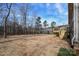 Exterior showcasing the back of the home, including a new deck and partially wooded backyard at 1202 Louise Ln, Albemarle, NC 28001
