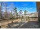 Spacious wooden deck overlooking a large backyard with mature trees, offering privacy and natural beauty at 1202 Louise Ln, Albemarle, NC 28001