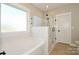 Modern bathroom with a soaking tub and a glass-enclosed shower area at 1202 Louise Ln, Albemarle, NC 28001