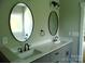 Modern bathroom with double sink vanity and oval mirrors at 1202 Louise Ln, Albemarle, NC 28001
