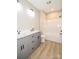 Bathroom featuring a gray double vanity, toilet, and shower at 1202 Louise Ln, Albemarle, NC 28001