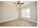 Bedroom featuring a ceiling fan, large window, and wood-look flooring at 1202 Louise Ln, Albemarle, NC 28001