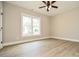 Bright bedroom features a ceiling fan and a large window at 1202 Louise Ln, Albemarle, NC 28001