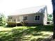 Back exterior of house featuring a deck, siding and brick foundation at 1202 Louise Ln, Albemarle, NC 28001