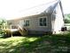 Exterior of house with deck, gray siding, and well-manicured lawn at 1202 Louise Ln, Albemarle, NC 28001