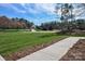 Exterior view showing well-manicured lawns and a paved walkway on a sunny day at 1202 Louise Ln, Albemarle, NC 28001