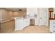Modern kitchen with white cabinets, stainless steel appliances, and a gray backsplash at 1202 Louise Ln, Albemarle, NC 28001