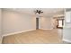Spacious open-plan living area with wood floors, neutral walls, and a ceiling fan at 1202 Louise Ln, Albemarle, NC 28001