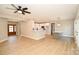 Open concept living area with wood floors and seamless flow to a modern kitchen with white cabinets at 1202 Louise Ln, Albemarle, NC 28001