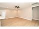 Well-lit living space with wood floors, a ceiling fan, and neutral wall paint, ready for personalization at 1202 Louise Ln, Albemarle, NC 28001