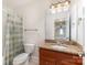 Bathroom features vanity with granite counters, sink, toilet, shower, and mirror at 125 Whiterock Dr, Mount Holly, NC 28120