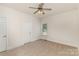 Bedroom with neutral decor features ceiling fan and window with backyard views at 125 Whiterock Dr, Mount Holly, NC 28120