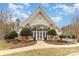 Elegant clubhouse entrance with manicured landscaping, stone accents, and decorative shrubbery at 125 Whiterock Dr, Mount Holly, NC 28120