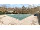 Community pool covered for the off-season, surrounded by a concrete deck and a wrought iron fence at 125 Whiterock Dr, Mount Holly, NC 28120