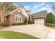 Spacious driveway leading to a well-maintained brick home with a two-car garage at 125 Whiterock Dr, Mount Holly, NC 28120
