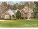 Charming brick home with manicured lawn and mature trees offers timeless curb appeal at 125 Whiterock Dr, Mount Holly, NC 28120