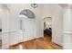 Elegant foyer with hardwood floors, white columns, and a view into the living area at 125 Whiterock Dr, Mount Holly, NC 28120