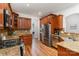 Gourmet kitchen with stainless steel appliances and rich wood cabinetry at 125 Whiterock Dr, Mount Holly, NC 28120