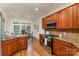 Kitchen featuring wood cabinets, granite countertops, stainless steel appliances, and natural light at 125 Whiterock Dr, Mount Holly, NC 28120