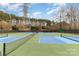 Well-maintained tennis courts with blue and green surfaces, set against a backdrop of lush greenery at 125 Whiterock Dr, Mount Holly, NC 28120