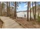Beautiful waterfront view featuring a wooden boardwalk, seating, and a serene lake with boat docks at 125 Whiterock Dr, Mount Holly, NC 28120