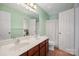 Bright bathroom featuring a double sink vanity, and shower with white patterned curtain at 12820 Settlers Trail Ct, Charlotte, NC 28278