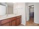 Bathroom featuring a double vanity with wood cabinets, a large mirror, and neutral wall paint at 12820 Settlers Trail Ct, Charlotte, NC 28278