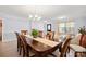 Dining room featuring hardwood floors, neutral colored walls, and chandelier lighting at 12820 Settlers Trail Ct, Charlotte, NC 28278