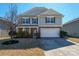 Charming two-story home with a well-maintained front yard and attached two-car garage at 12820 Settlers Trail Ct, Charlotte, NC 28278