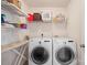 Functional laundry room with washer, dryer, and plenty of storage space at 12820 Settlers Trail Ct, Charlotte, NC 28278