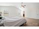 Spacious main bedroom features light wood floors and great natural light from the large windows at 12820 Settlers Trail Ct, Charlotte, NC 28278