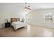 Spacious main bedroom features light wood floors, a ceiling fan, and great natural light from the large windows at 12820 Settlers Trail Ct, Charlotte, NC 28278