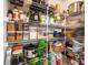 Walk-in pantry with adjustable shelving, providing ample storage space for groceries at 12820 Settlers Trail Ct, Charlotte, NC 28278