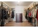 Walk-in closet featuring a wooden dresser with plenty of storage space, and metal clothing racks at 12820 Settlers Trail Ct, Charlotte, NC 28278