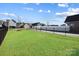 Spacious backyard with a lush lawn, privacy fence, and plenty of room for outdoor activities at 136 Kingston Dr, Locust, NC 28097