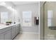 Bathroom features dual sinks, granite countertops, large mirror, and a glass-enclosed shower at 136 Kingston Dr, Locust, NC 28097