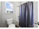 Bathroom with a toilet, vanity area, and ample lighting at 136 Kingston Dr, Locust, NC 28097