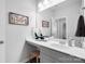 Bathroom vanity featuring a white sink, large mirror, and modern decor at 136 Kingston Dr, Locust, NC 28097