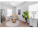 Bright bedroom features natural light, neutral walls, accent chair, and stylish décor at 136 Kingston Dr, Locust, NC 28097