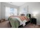 Cozy bedroom with a bed, neutral decor, and a bright window at 136 Kingston Dr, Locust, NC 28097