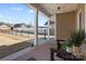 View of the covered patio with a view of the backyard with black aluminum fence and neighboring homes at 136 Kingston Dr, Locust, NC 28097