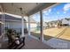 This covered patio looks out to a fenced backyard and features outdoor seating and string lights at 136 Kingston Dr, Locust, NC 28097