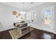 Bright dining area featuring a wooden table, bench seating, a view of the backyard, and hardwood floors at 136 Kingston Dr, Locust, NC 28097