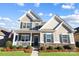 Charming two-story home with a front porch, manicured lawn, and attractive stone accents at 136 Kingston Dr, Locust, NC 28097