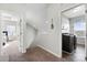 Hallway with stairs leading up, laundry room to the right, bedroom to the left at 136 Kingston Dr, Locust, NC 28097